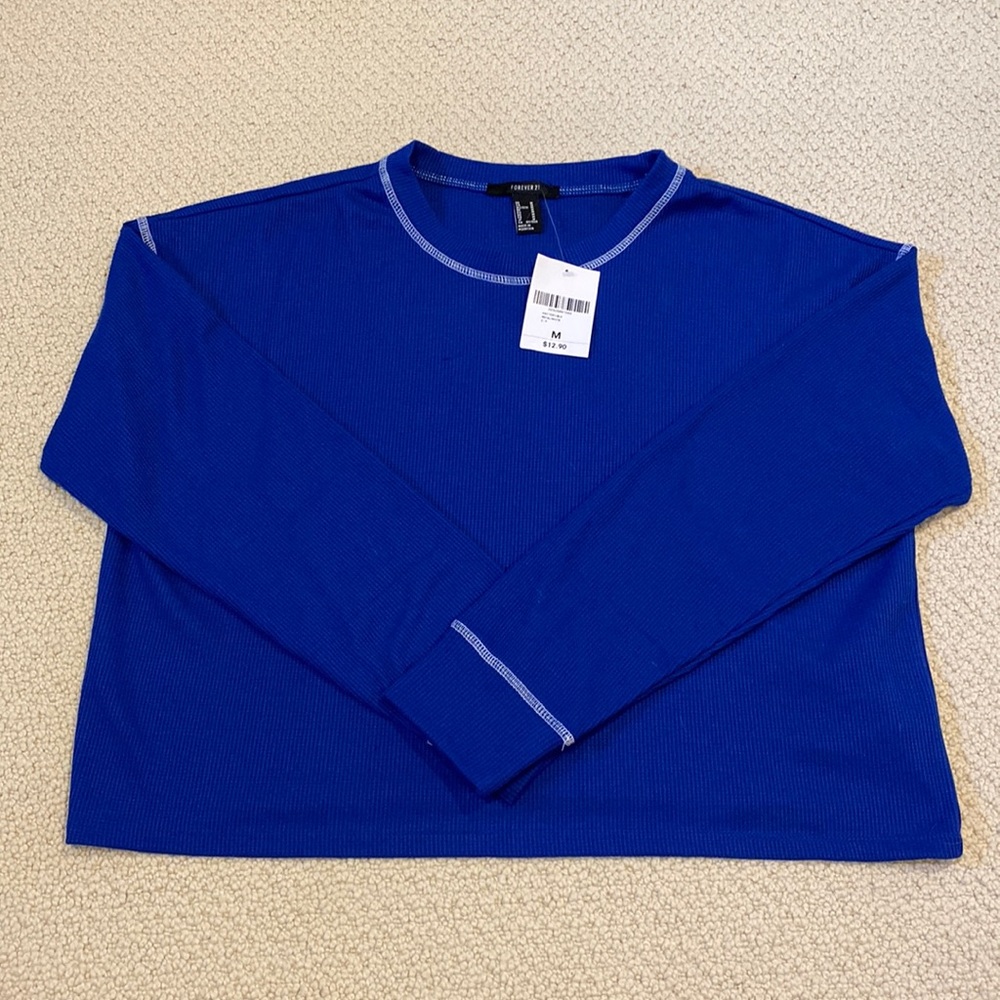 Royal blue H & M knit top with white stitching